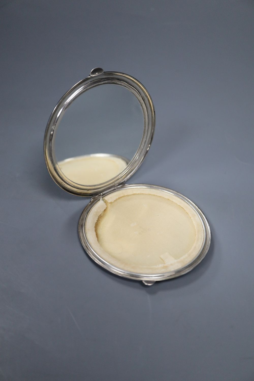 A 1950s silver and green guilloche enamel circular compact, 85mm Birmingham, 1950.